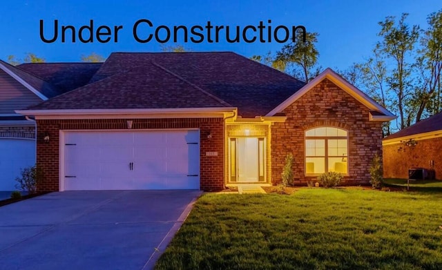 view of front of property with a front lawn and a garage