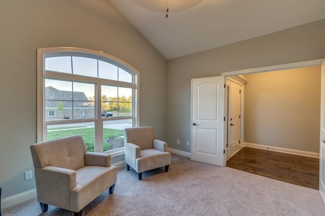 sitting room featuring lofted ceiling and hardwood / wood-style flooring