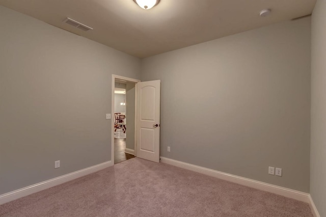 spare room with dark carpet