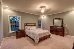 bedroom with light carpet and ceiling fan