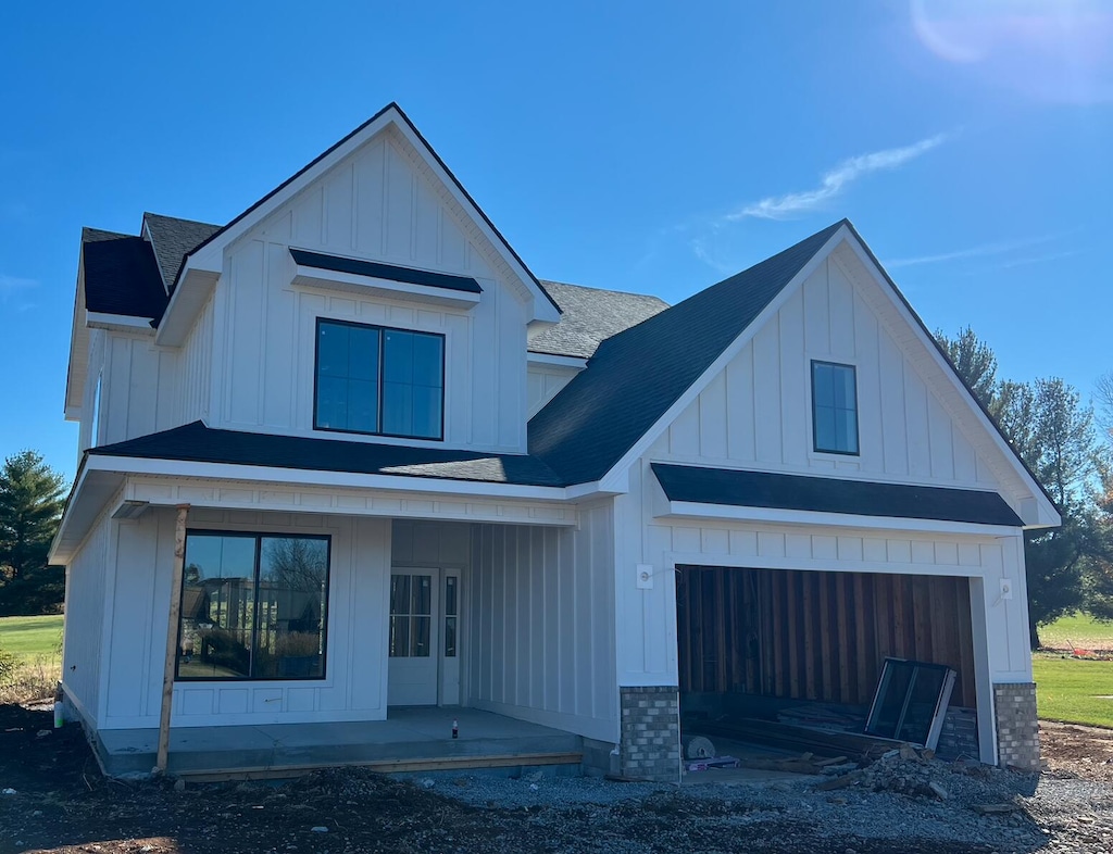 modern inspired farmhouse with a garage