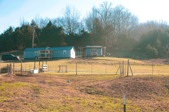 view of yard featuring an outdoor structure and a rural view