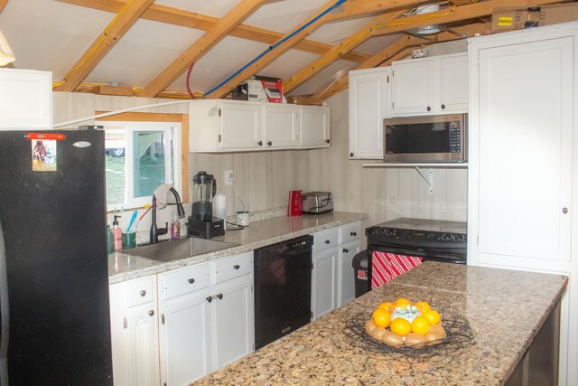 kitchen with lofted ceiling with beams, sink, white cabinetry, light stone countertops, and black appliances