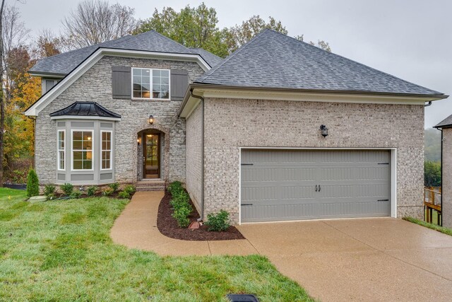 view of front of home featuring a front yard and a garage