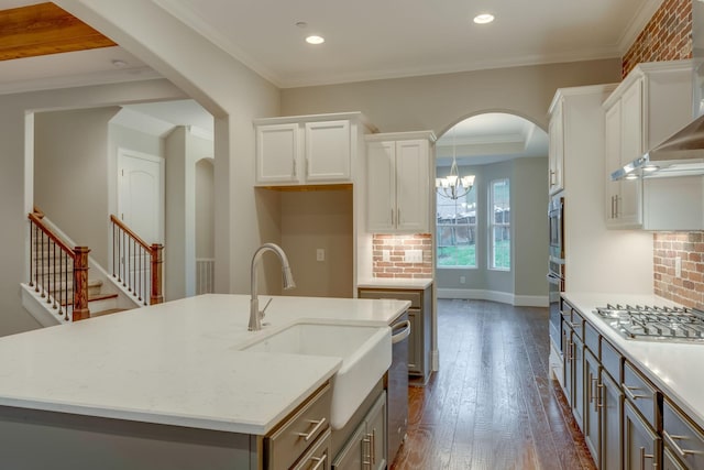 kitchen with dark hardwood / wood-style floors, an island with sink, gray cabinets, white cabinets, and an inviting chandelier