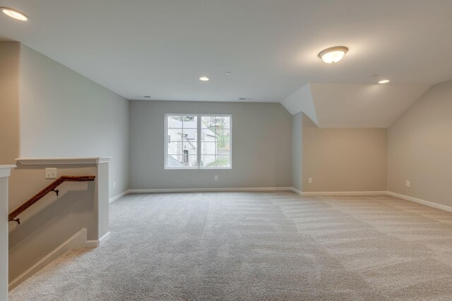 bonus room featuring light colored carpet and vaulted ceiling