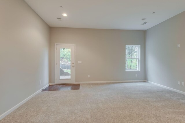 carpeted empty room featuring plenty of natural light