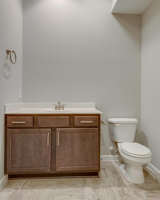 bathroom featuring toilet and vanity