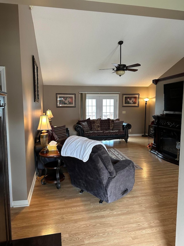 bedroom with vaulted ceiling, light hardwood / wood-style flooring, and ceiling fan