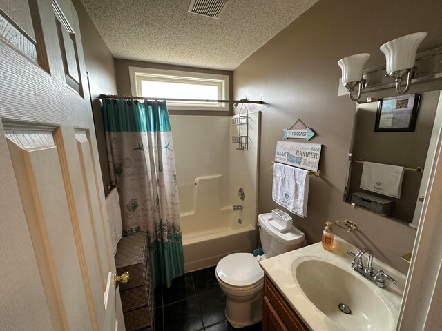 full bathroom featuring tile patterned flooring, shower / bath combo, a textured ceiling, toilet, and vanity