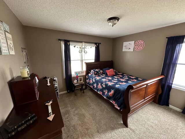 bedroom with carpet and a textured ceiling