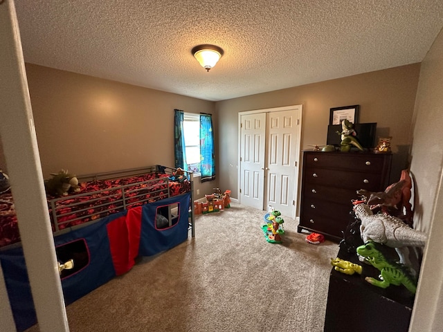 bedroom featuring carpet and a textured ceiling