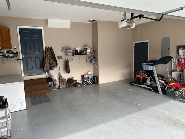 garage featuring electric panel and a garage door opener