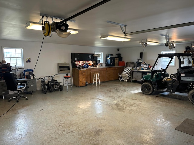 garage with a workshop area and a garage door opener