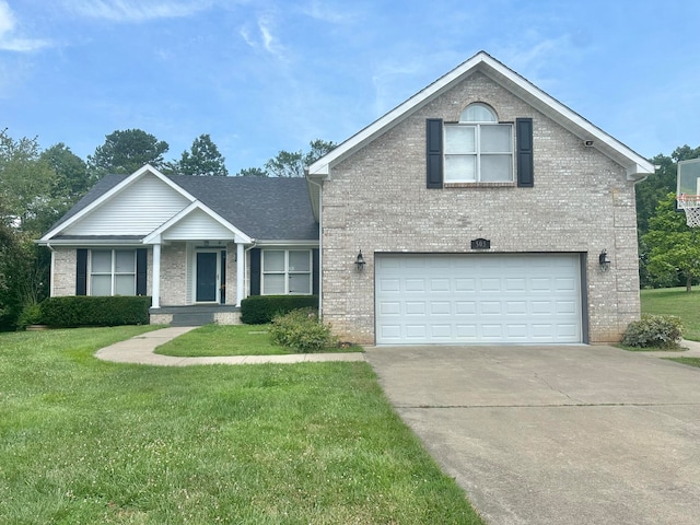 view of front of home with a garage and a front lawn