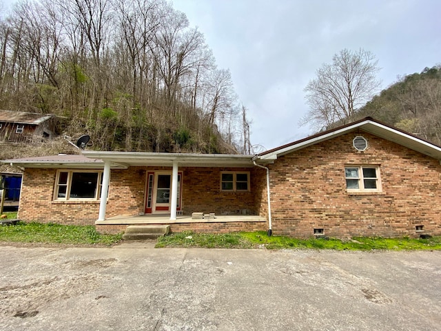 back of property featuring a porch