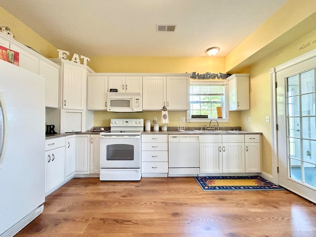 kitchen featuring white cabinets, white appliances, sink, and light wood-type flooring