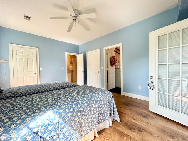 bedroom with dark hardwood / wood-style flooring and ceiling fan