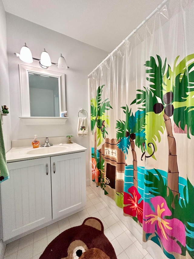 bathroom with tile floors and vanity with extensive cabinet space