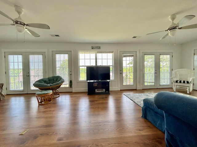 living room with plenty of natural light, ceiling fan, and french doors