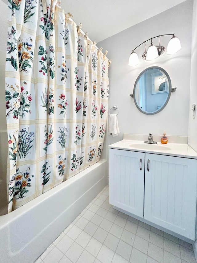 bathroom with tile flooring, shower / bathtub combination with curtain, and vanity