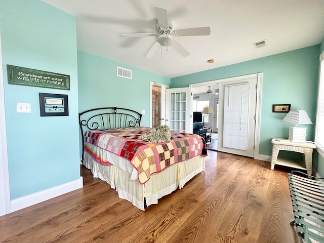 bedroom featuring ceiling fan, hardwood / wood-style floors, and french doors