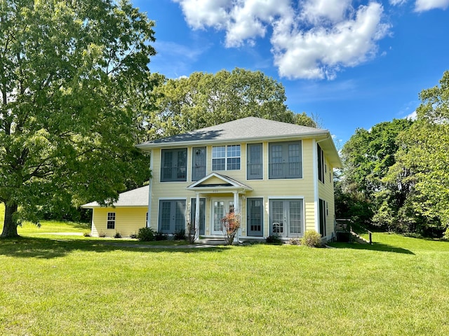 colonial-style house with a front lawn