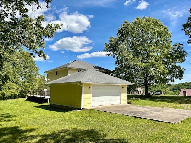 exterior space featuring a wooden deck, a yard, and a garage