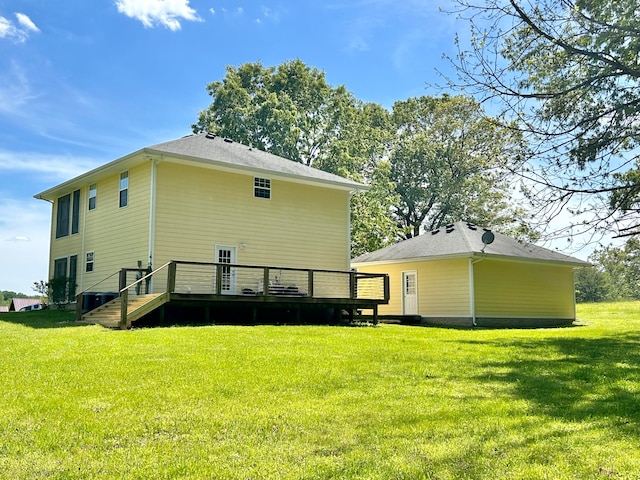 back of property featuring a deck and a yard