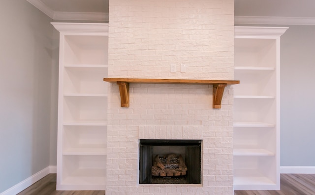 room details featuring built in features, a brick fireplace, ornamental molding, and wood-type flooring