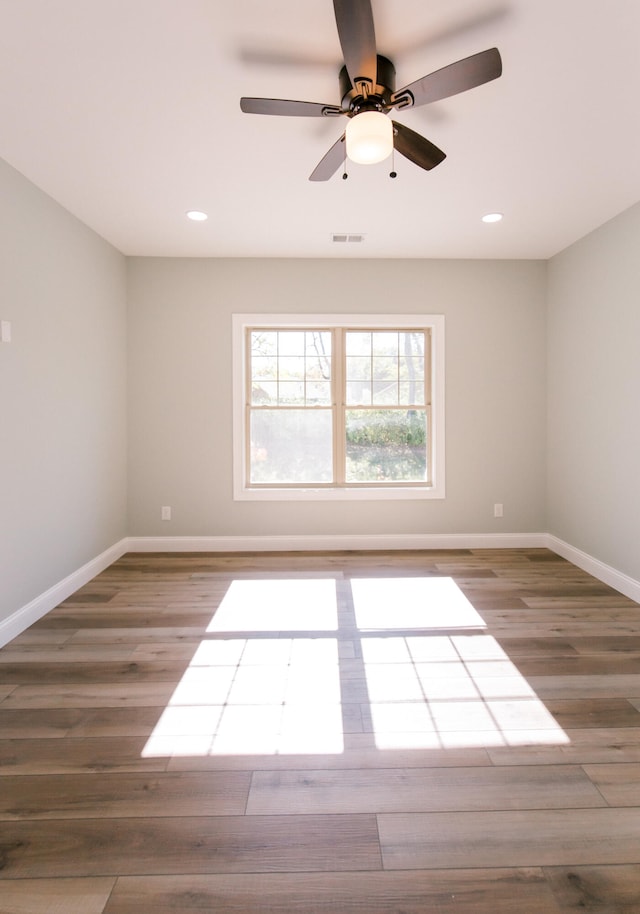 empty room with ceiling fan and light wood-type flooring