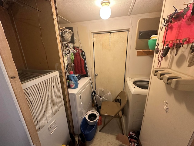 laundry area featuring tile floors and washer / dryer