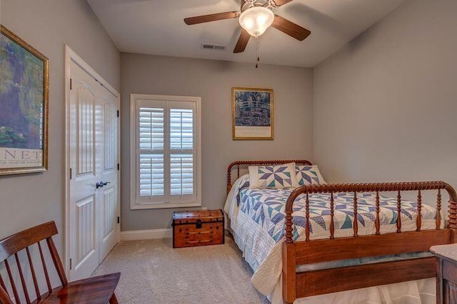 bedroom featuring light carpet, a closet, and ceiling fan