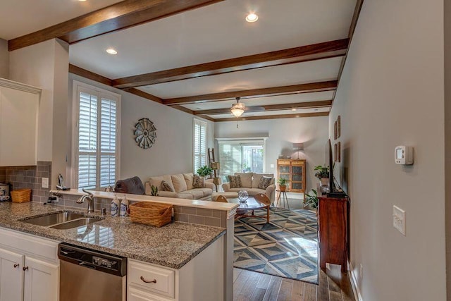 kitchen featuring white cabinets, stainless steel dishwasher, ceiling fan, and sink