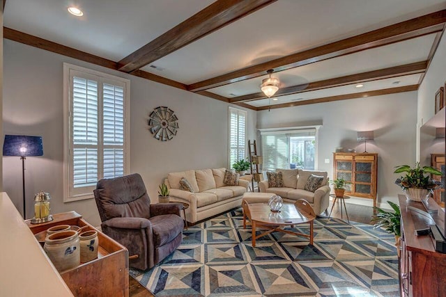 living room featuring ceiling fan, beam ceiling, and hardwood / wood-style floors