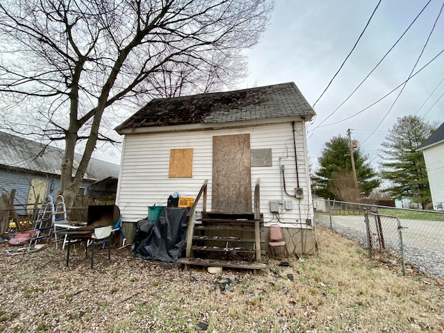 back of property featuring an outdoor structure