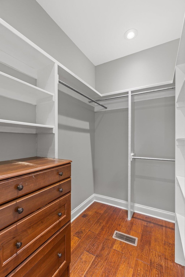 spacious closet featuring dark wood-style floors and visible vents