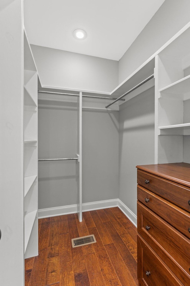 walk in closet with dark wood-style floors and visible vents