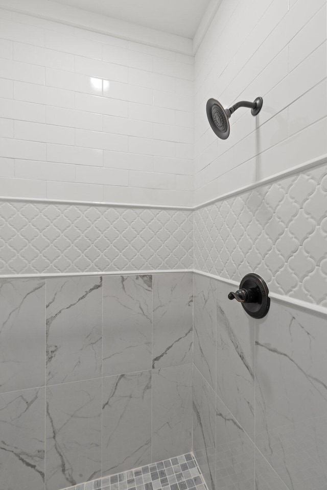 full bath with a tile shower