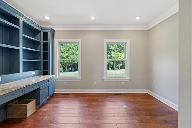 unfurnished office featuring baseboards, dark wood-type flooring, and ornamental molding