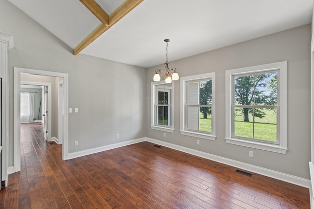 spare room featuring dark wood-style floors, visible vents, and baseboards