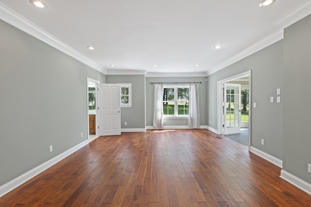 unfurnished living room with dark wood finished floors, baseboards, and ornamental molding