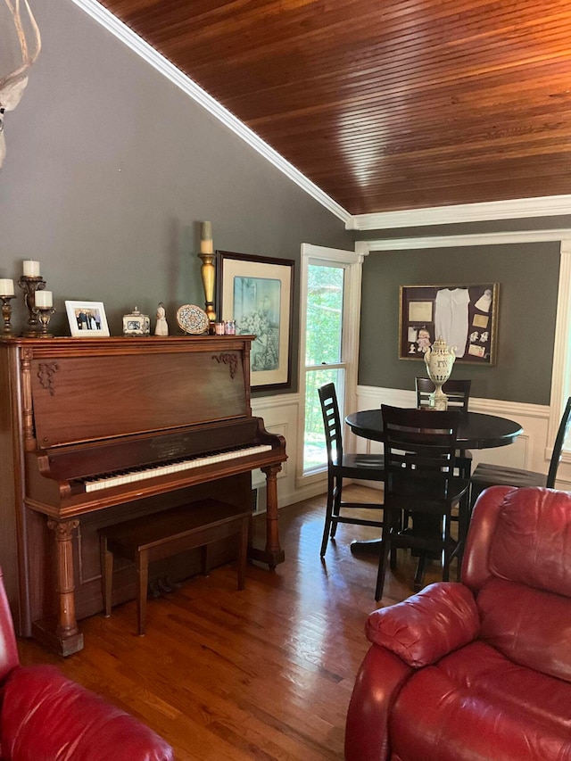 living room featuring dark hardwood / wood-style flooring, crown molding, vaulted ceiling, and wooden ceiling