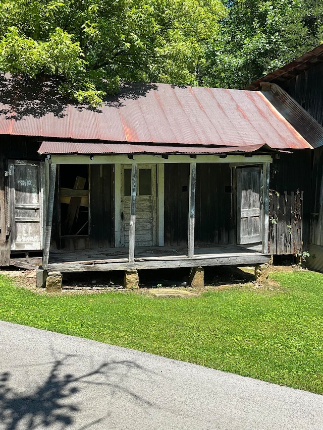 exterior space featuring a lawn and covered porch