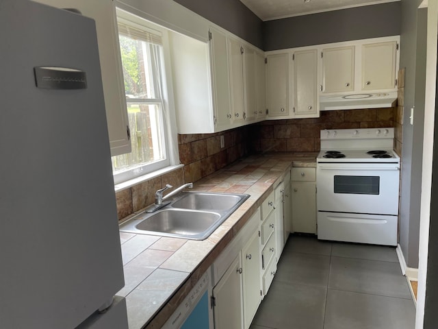 kitchen with tile counters, fridge with ice dispenser, white electric range oven, and tasteful backsplash