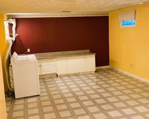 interior space featuring a textured ceiling and light tile floors