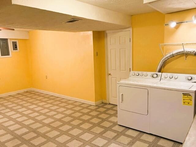 washroom with separate washer and dryer and light tile floors