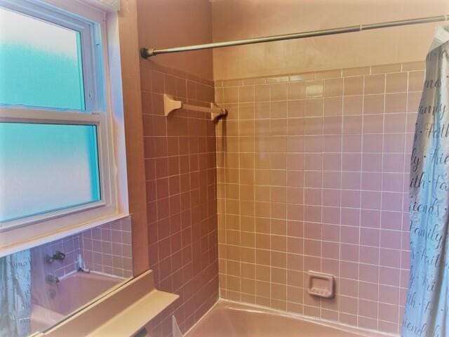 bathroom with shower / bath combo with shower curtain