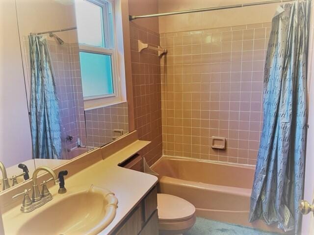 full bathroom with shower / tub combo, toilet, and large vanity