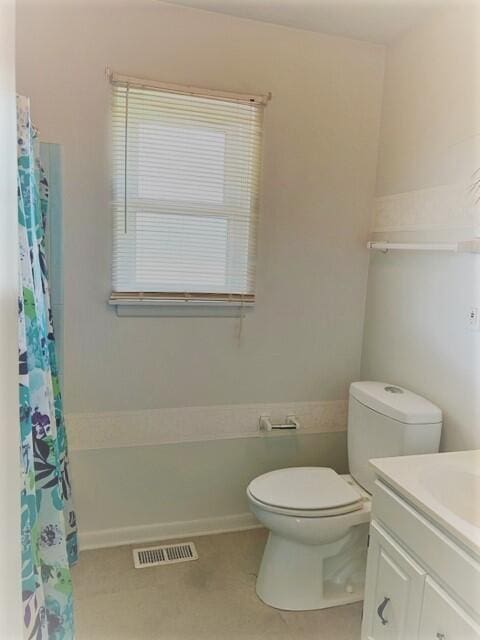 bathroom featuring vanity, tile flooring, and toilet